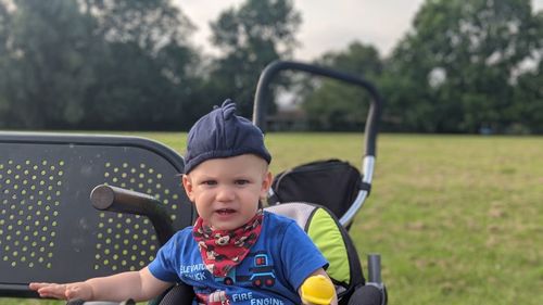 Portrait of cute boy sitting outdoors