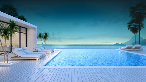 Summer ,beach lounge, sun loungers on sunbathing deck and private swimming pool at luxury villa