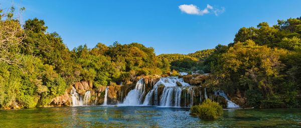 Scenic view of waterfall against sky during autumn