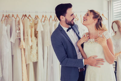 Young couple standing against wall