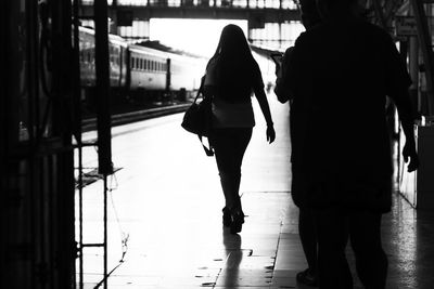 Rear view of women walking on footpath