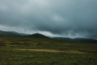 Scenic view of lake district lmisty andscape against sky with rugged moorland in the foreground 