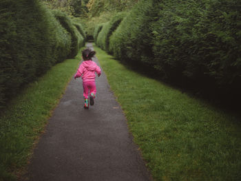 Full length of girl walking on field