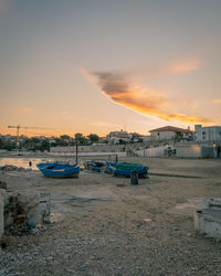 Boats moored at harbor during sunset