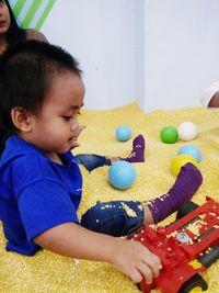 Cute boy playing with toy