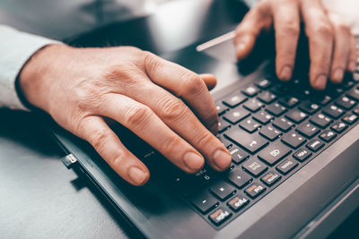 Midsection of man using laptop