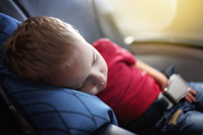 Cute boy sleeping in car