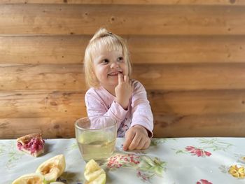 Portrait of boy eating food on table