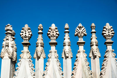 Low angle view of sculpture against clear blue sky