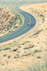 High angle view of people cycling on country road