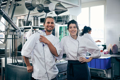 Portrait of chefs smiling in commercial kitchen