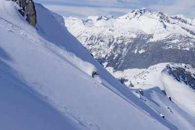 Person skiing on snowcapped mountain