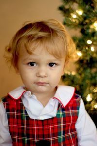 Portrait of cute baby girl with christmas tree