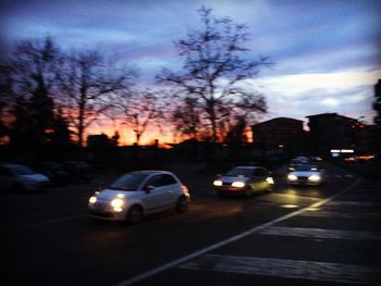 Cars on road at sunset