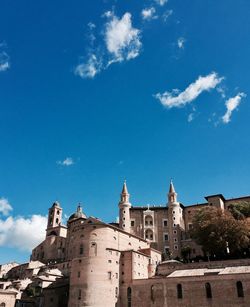 Low angle view of historical building against blue sky