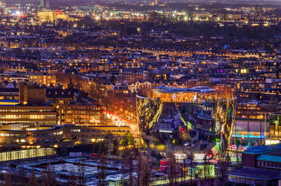 View of the city in the blue hour with in the front the reflecting bowl-shaped depot building