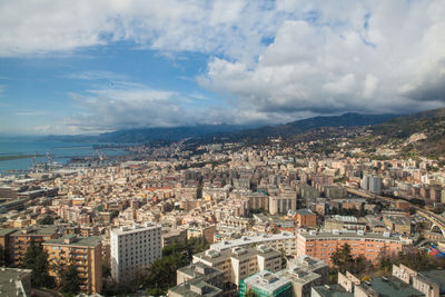 High angle view of cityscape against cloudy sky