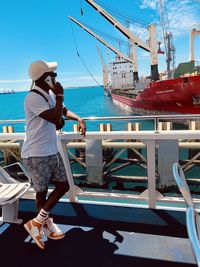 Rear view of man standing in boat