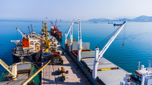 Boats in sea against clear sky