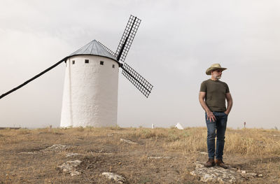 Man standing on field against sky