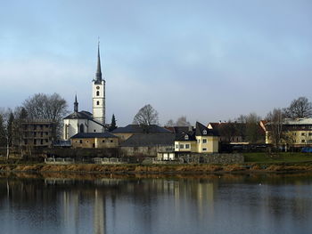 River amidst buildings against sky