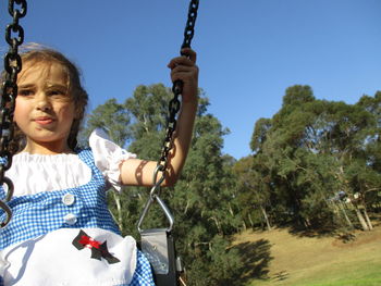 Cute girl swinging at park