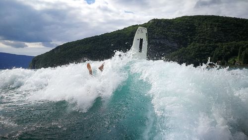 Water splashing in sea against sky