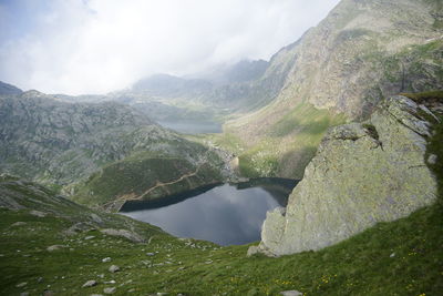 Scenic view of lake and mountains against sky