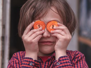 Close-up portrait of girl holding apple