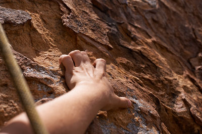 Cropped image of person on rock