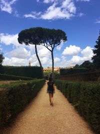 Rear view of woman walking at boboli gardens