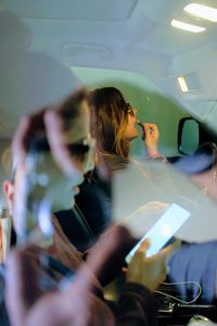 Young woman taking selfie in car