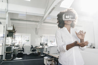 Woman wearing vr glasses in office