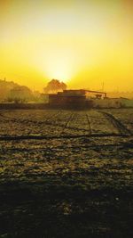 Scenic view of field against sky during sunset