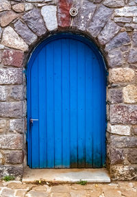 Closed blue door of old building