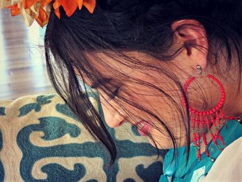 Side view of smiling young woman wearing earring