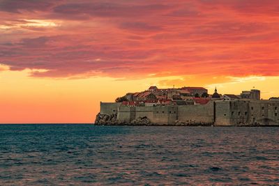 Scenic view of sea against orange sky