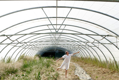 Woman standing by plants