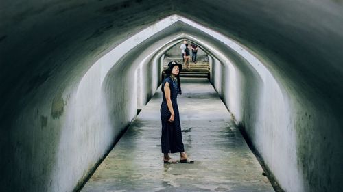 Woman walking in tunnel