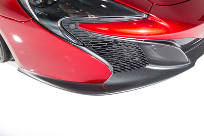 Close-up of red car over white background