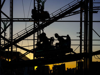 Low angle view of men working at construction site