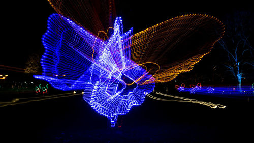 Firework display over illuminated city at night