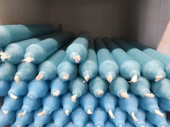 Close-up of blue candles stacks in container at store