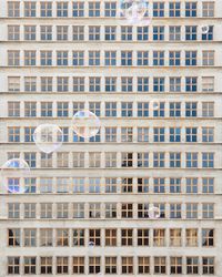 Bubbles flying against building in city