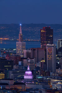 Illuminated buildings in city at night,