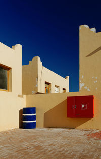 Cropped built structures against clear blue sky