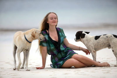 Full length of young woman with dog