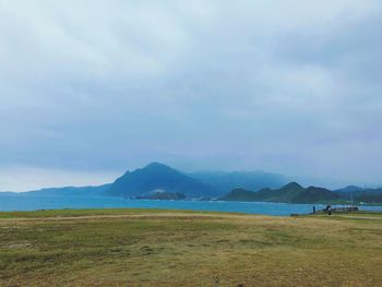 View of beach against cloudy sky