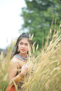 Portrait of woman standing in field
