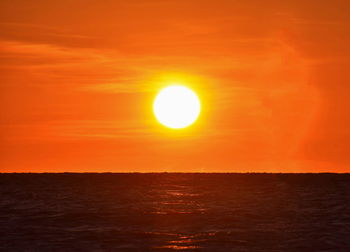 Scenic view of sea against romantic sky at sunset